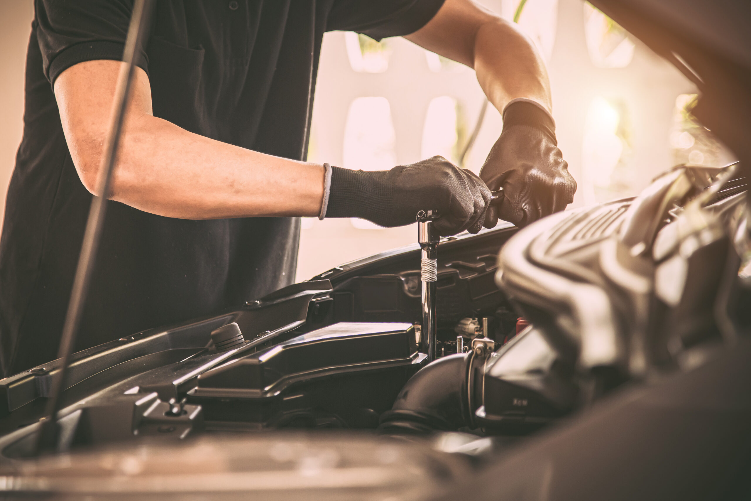 Close-up hand auto mechanic using the wrench to repairing car engine problem. Concepts of check and inspection car care maintenance and servicing.